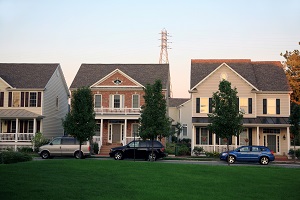 outside of several homes with cars parked on the street