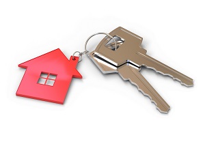 two keys with a house keychain